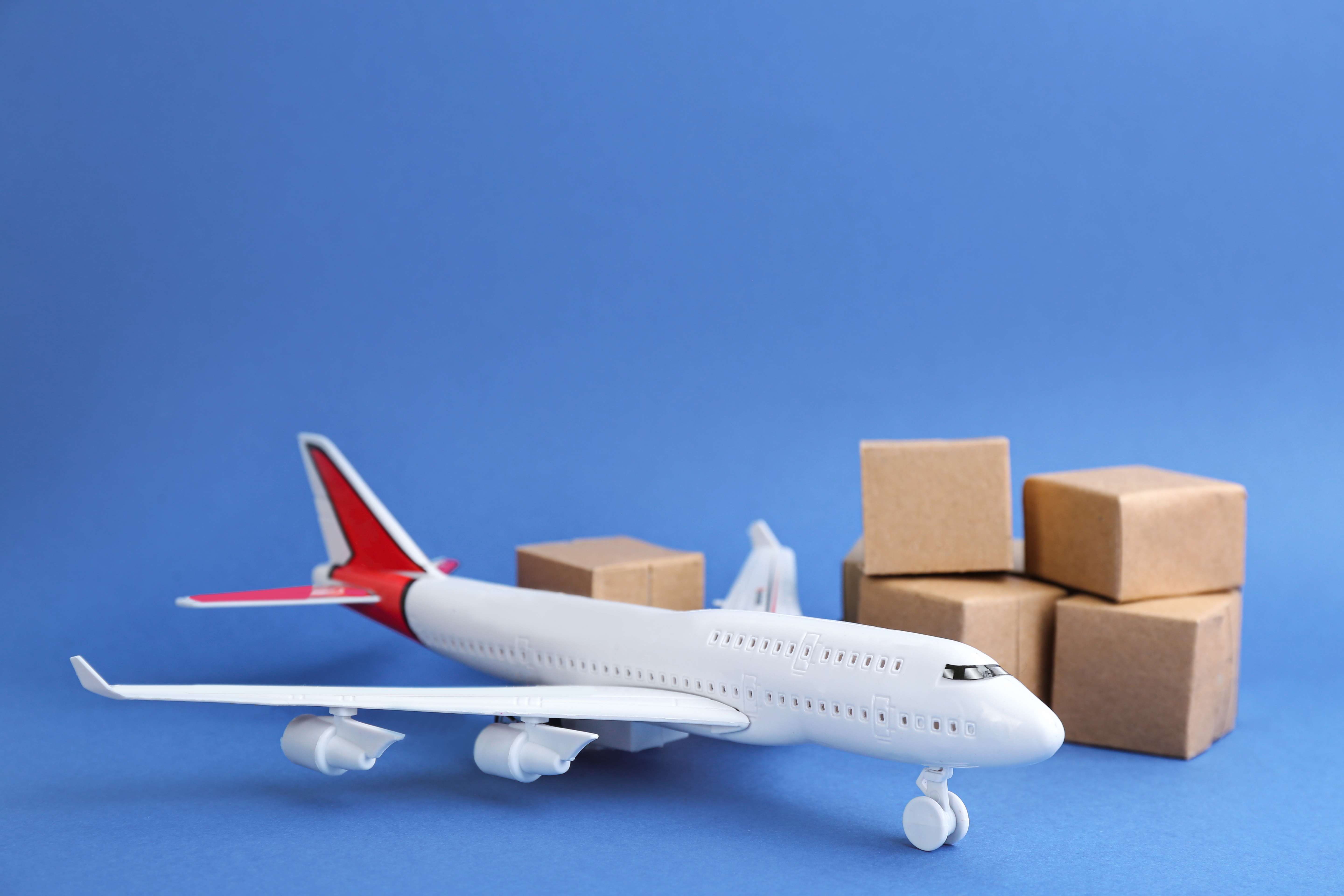 Toy Airplane With Boxes on Blue Background 2026 03 10 03 57 46 Utc